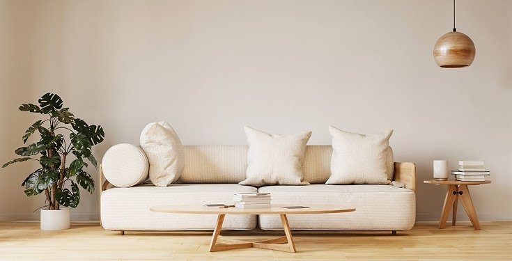 Minimalist living room with a cream sofa and copper pendant lamp - interior design services in Bhubaneswar and Cuttack